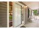 A close-up of a charming front porch with rocking chairs and a white door and sidelight window at 140 Baron Cir, Youngsville, NC 27596