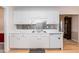 Practical kitchen featuring white cabinetry, stainless steel backsplash, and modern appliances, offering an ideal cooking environment at 140 Baron Cir, Youngsville, NC 27596