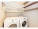 Functional laundry room with washer, dryer, and storage shelves, designed to make laundry tasks more manageable and organized at 140 Baron Cir, Youngsville, NC 27596