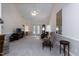 A spacious living room featuring carpet floors, a ceiling fan, and access to the backyard through french doors at 140 Baron Cir, Youngsville, NC 27596