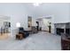 Spacious living room with vaulted ceiling, stone fireplace, and comfortable seating area, perfect for relaxing and entertaining guests at 140 Baron Cir, Youngsville, NC 27596