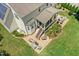 Home featuring a screened porch, outdoor patio with seating, and well-manicured lawn, captured from an aerial perspective at 142 Scarlet Oak Run, Clayton, NC 27520