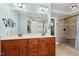 Elegant bathroom with double vanity, large mirror, and walk-in shower at 142 Scarlet Oak Run, Clayton, NC 27520