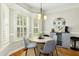 Dining area featuring a bay window, chandelier, and modern decor at 142 Scarlet Oak Run, Clayton, NC 27520