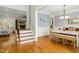 Open-concept dining area with hardwood floors, views of fireplace, and stylish furnishings at 142 Scarlet Oak Run, Clayton, NC 27520