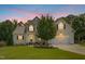 Charming two-story home with well-maintained lawn, mature landscaping, and attached two-car garage at 142 Scarlet Oak Run, Clayton, NC 27520