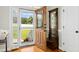 Inviting foyer with hardwood floors, a coat rack, and a view of the front yard at 142 Scarlet Oak Run, Clayton, NC 27520