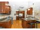 Well-equipped kitchen featuring granite counters, wood cabinets, and modern appliances at 142 Scarlet Oak Run, Clayton, NC 27520