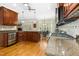 Open kitchen with granite countertops, wood cabinets and views to the breakfast nook at 142 Scarlet Oak Run, Clayton, NC 27520