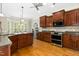 Expansive kitchen with stainless appliances, granite counters, and adjoining breakfast nook at 142 Scarlet Oak Run, Clayton, NC 27520
