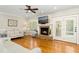 Relaxing living room with a stone fireplace, natural light, and comfortable seating at 142 Scarlet Oak Run, Clayton, NC 27520