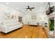 Spacious living room featuring hardwood floors, comfortable seating, and a fireplace at 142 Scarlet Oak Run, Clayton, NC 27520