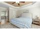 Bright main bedroom featuring a tray ceiling, ceiling fan, and neutral tones at 142 Scarlet Oak Run, Clayton, NC 27520