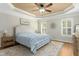 Serene main bedroom with tray ceiling, ceiling fan, and natural light at 142 Scarlet Oak Run, Clayton, NC 27520