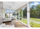 Bright sunroom features walls of windows, ceiling fans, wood floors and views of the large backyard at 142 Scarlet Oak Run, Clayton, NC 27520