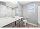 Modern bathroom features a gray vanity with white countertop, a toilet, and shower-tub combo at 147 Sunfish St, Smithfield, NC 27577