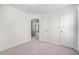A bright bedroom features neutral walls, plush carpet, and an open doorway to the next room at 147 Sunfish St, Smithfield, NC 27577