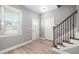 Bright entryway with wood floors, white doors, stairs with black metal and wooden railing, and natural light at 147 Sunfish St, Smithfield, NC 27577