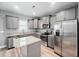 Modern kitchen with gray cabinets, stainless steel appliances, granite countertops and an island at 147 Sunfish St, Smithfield, NC 27577