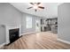 Open-concept living room flowing into the kitchen, featuring a fireplace and stainless steel appliances at 147 Sunfish St, Smithfield, NC 27577