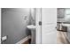 Stylish powder room with a pedestal sink and neutral paint, conveniently located near the kitchen at 147 Sunfish St, Smithfield, NC 27577