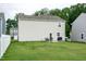Spacious backyard with a patio, outdoor seating, and lush green lawn at 1476 Burgundy Bluff Ln, Zebulon, NC 27597