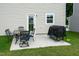 Cozy backyard patio with outdoor seating and a grill, perfect for entertaining at 1476 Burgundy Bluff Ln, Zebulon, NC 27597