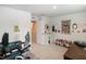 Bright bedroom with a desk, gaming chair, butterfly artwork, and access to storage at 1476 Burgundy Bluff Ln, Zebulon, NC 27597