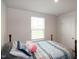 Bright bedroom showcasing a large window providing natural light and a comfortable bed at 1476 Burgundy Bluff Ln, Zebulon, NC 27597