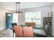Bright and airy dining area with modern decor and ample natural light streaming through the window at 1476 Burgundy Bluff Ln, Zebulon, NC 27597