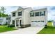 Inviting two-story home featuring a two-car garage, landscaped yard and charming front entrance at 1476 Burgundy Bluff Ln, Zebulon, NC 27597
