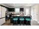 Modern kitchen featuring an island with seating, stainless steel appliances, and sleek dark cabinetry at 1476 Burgundy Bluff Ln, Zebulon, NC 27597