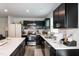 Updated kitchen featuring black cabinets, stainless steel appliances, and a large island with barstool seating at 1476 Burgundy Bluff Ln, Zebulon, NC 27597