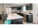 Modern kitchen featuring sleek black cabinetry, stainless steel appliances, and a spacious island with breakfast bar seating at 1476 Burgundy Bluff Ln, Zebulon, NC 27597
