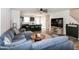 Bright open-concept living room featuring hardwood floors, modern ceiling fan, and comfortable seating area at 1476 Burgundy Bluff Ln, Zebulon, NC 27597