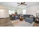 Cozy living room with hardwood floors, ceiling fan, and comfortable seating area with seamless integration to the dining area at 1476 Burgundy Bluff Ln, Zebulon, NC 27597