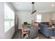 Cozy living room featuring a dining area, ample natural light, and stylish, modern decor at 1476 Burgundy Bluff Ln, Zebulon, NC 27597