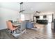 Open-concept living space featuring modern flooring, dining area, and kitchen with breakfast bar at 1476 Burgundy Bluff Ln, Zebulon, NC 27597