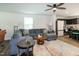 Comfortable living room featuring an open-concept layout, modern ceiling fan, and access to the adjacent kitchen at 1476 Burgundy Bluff Ln, Zebulon, NC 27597