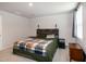 Bright bedroom with a king size bed, neutral carpet, and two windows with blinds at 1476 Burgundy Bluff Ln, Zebulon, NC 27597