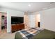 Spacious bedroom features a television, multiple closets and carpeted floors with natural light from windows at 1476 Burgundy Bluff Ln, Zebulon, NC 27597