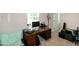 Bright office featuring a classic wood desk, modern lighting, and comfortable seating at 1476 Burgundy Bluff Ln, Zebulon, NC 27597