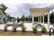 Community pool area features a pergola, fire pit, seating, and lush landscaping for relaxation at 1476 Burgundy Bluff Ln, Zebulon, NC 27597