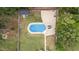 Overhead view of pool surrounded by a concrete patio, lounge chairs, and a storage shed at 149 Great Oak Dr, Garner, NC 27529