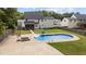 Aerial view of a backyard featuring an in-ground swimming pool, patio, and manicured lawn at 149 Great Oak Dr, Garner, NC 27529