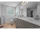Well-lit bathroom with double vanity, make-up table, and luxurious finishes and fixtures at 149 Great Oak Dr, Garner, NC 27529