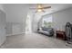 Spacious bedroom featuring natural light, plush carpeting, and a contemporary ceiling fan at 149 Great Oak Dr, Garner, NC 27529