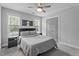Bedroom with a black bed, matching nightstands, and natural light from the two windows at 149 Great Oak Dr, Garner, NC 27529