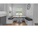 Charming breakfast nook with built in seating, marble table and serene backyard views at 149 Great Oak Dr, Garner, NC 27529