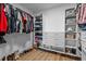 Walk-in closet with custom shelves, drawers, clothing rods, and hardwood floor at 149 Great Oak Dr, Garner, NC 27529